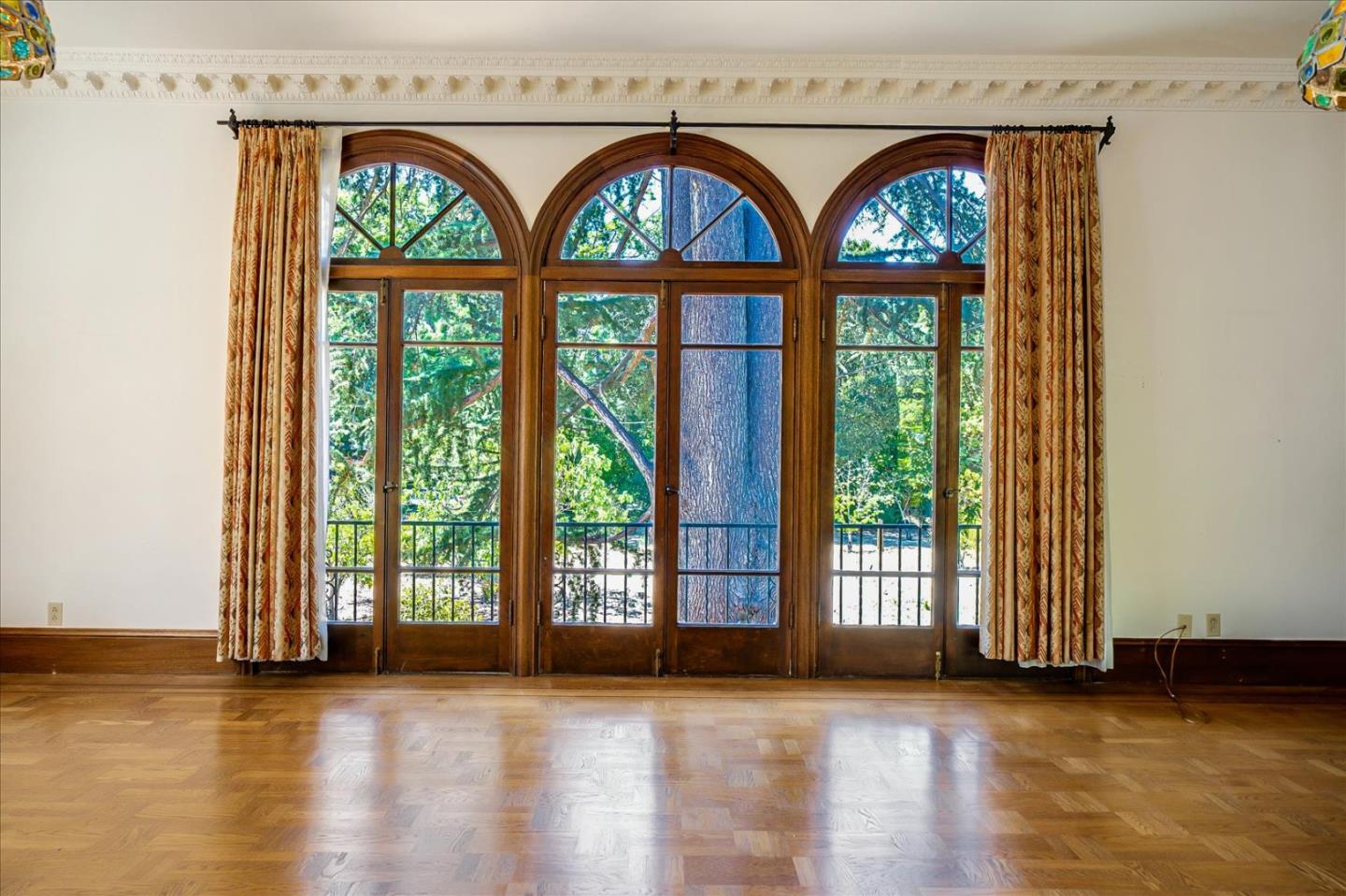 167 Almendral Avenue Atherton, CA 94027 - Photo 3 of 50 an empty room with wooden floor and a floor to ceiling window