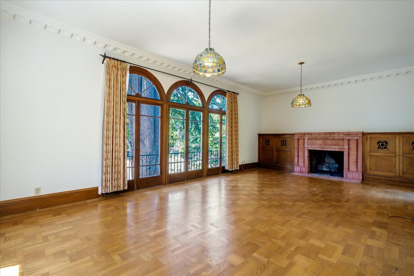 167 Almendral Avenue Atherton, CA 94027 - Photo 4 of 50 a view of an empty room with a fireplace and a window