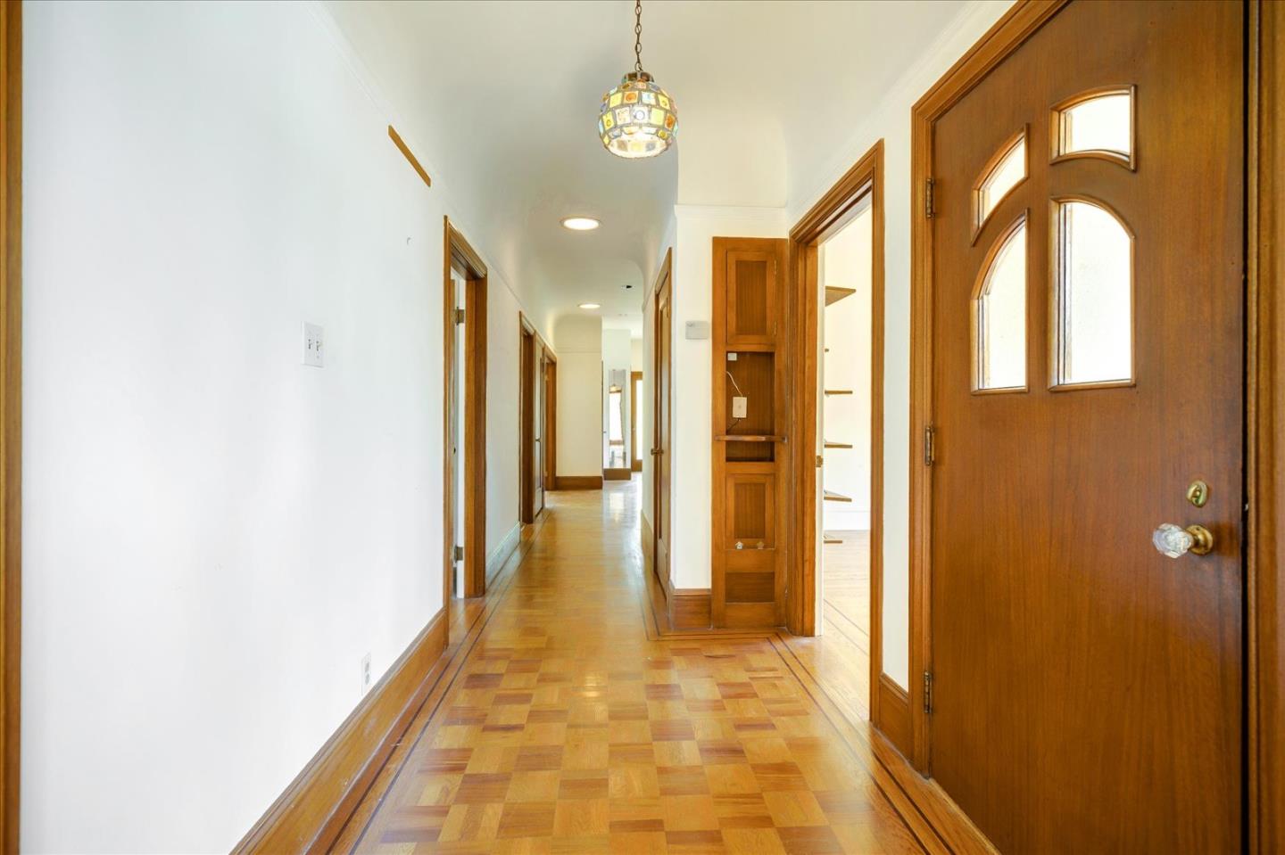 167 Almendral Avenue Atherton, CA 94027 - Photo 7 of 50 a view of a hallway with wooden floor and a bathroom