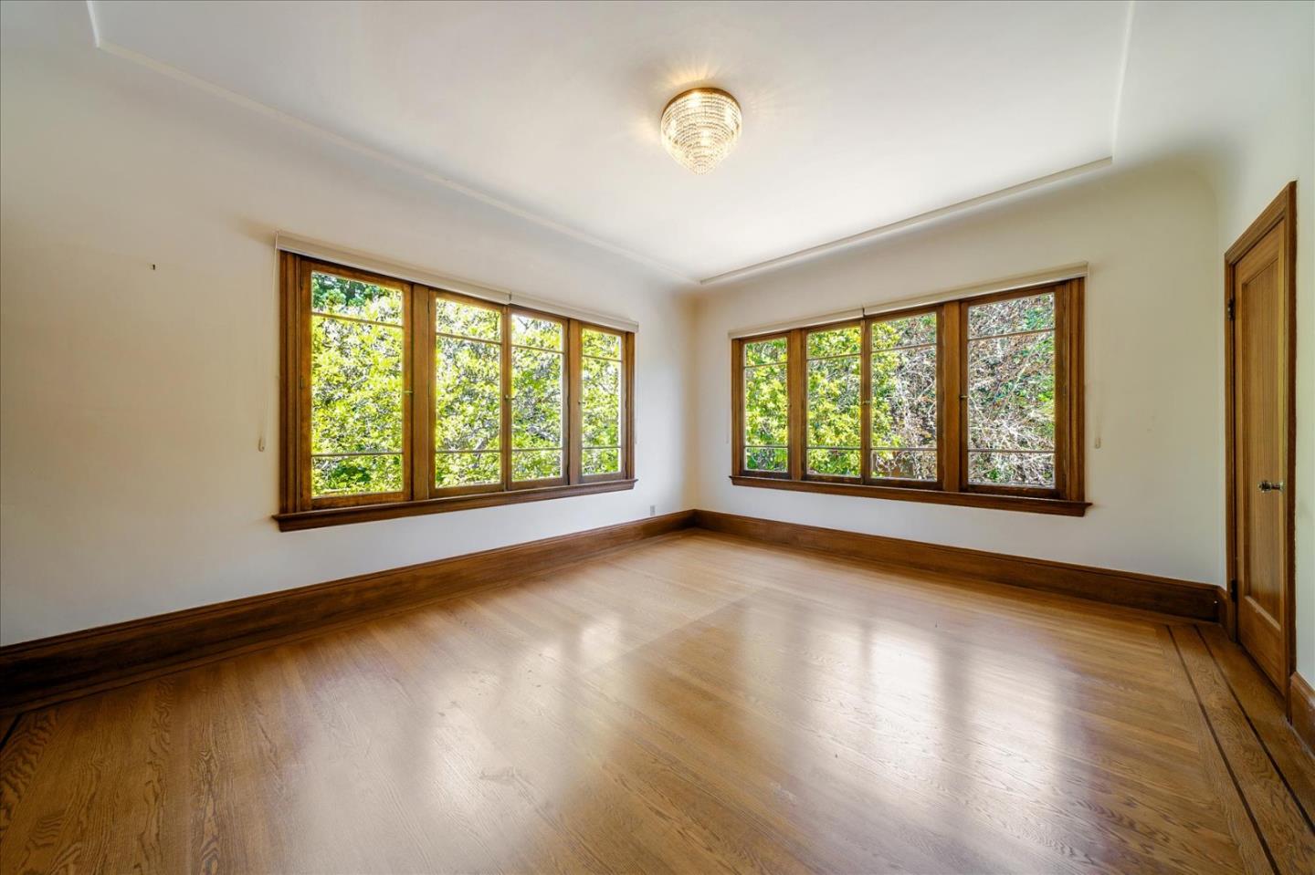 167 Almendral Avenue Atherton, CA 94027 - Photo 9 of 50 a view of an empty room with wooden floor and a window