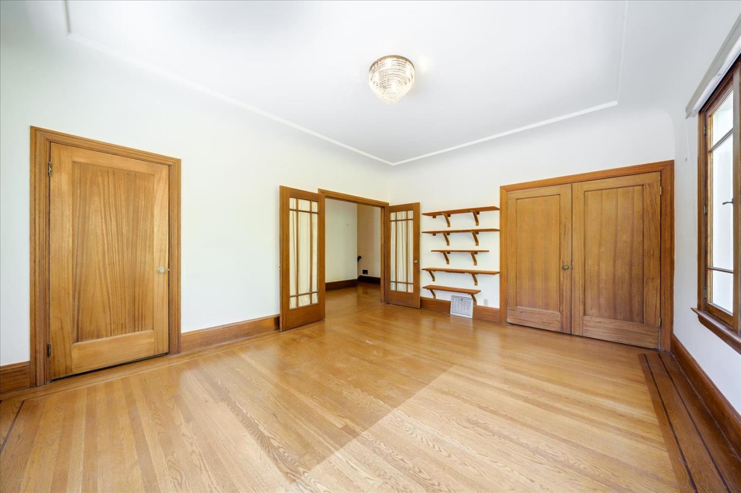 167 Almendral Avenue Atherton, CA 94027 - Photo 10 of 50 a view of an empty room with a window and wooden floor