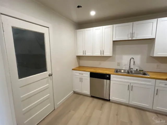 a kitchen with granite countertop white cabinets and white appliances