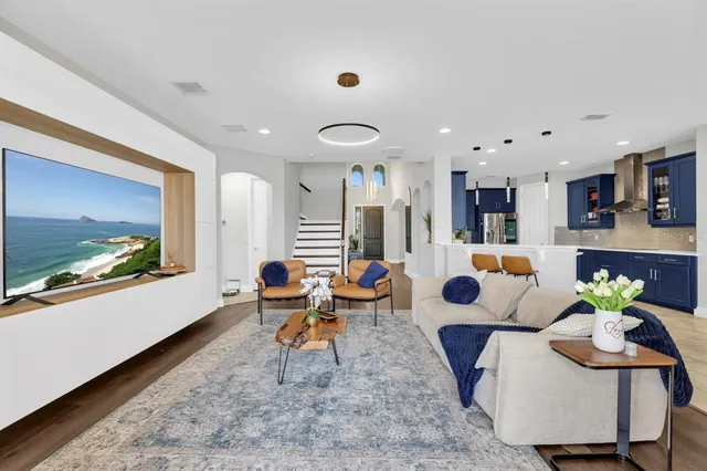 a large kitchen with stainless steel appliances kitchen island granite countertop a table and chairs in it