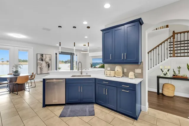 a bathroom with a granite countertop sink a toilet a mirror and shower