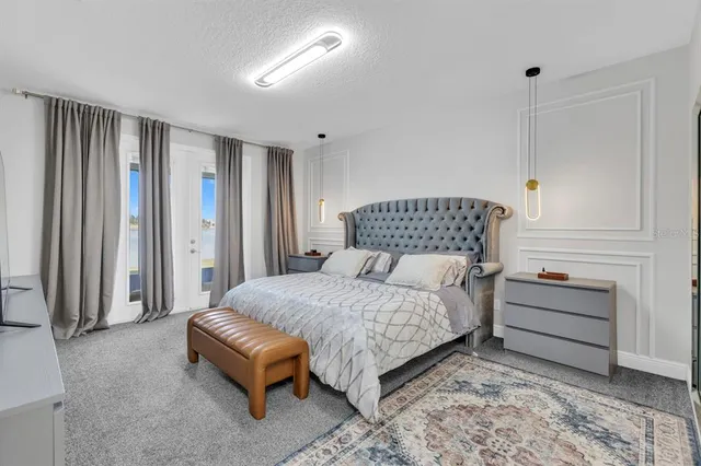 a view of a hallway with wooden floor and a bathroom