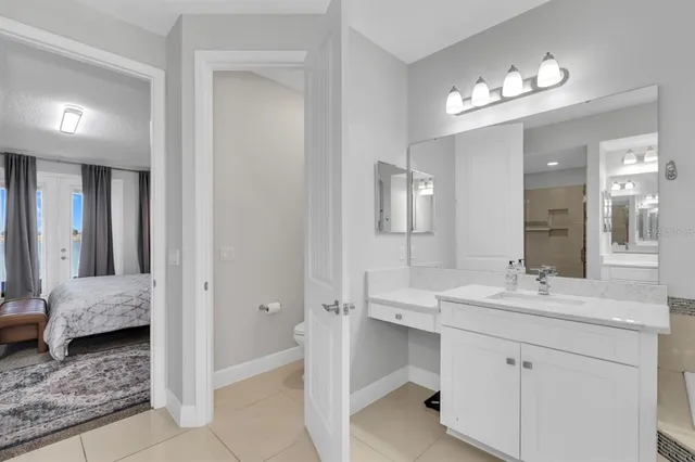 a bathroom with a bathtub a double vanity sink and a mirror
