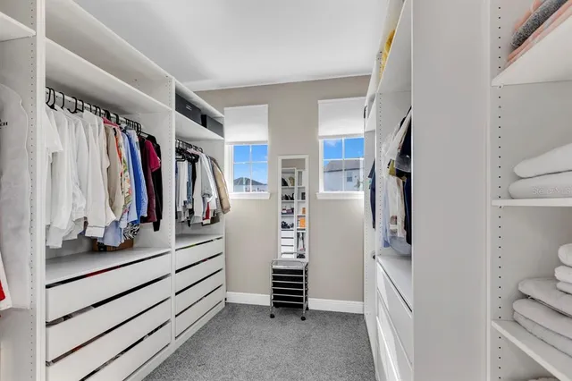 a bedroom with two beds and a window