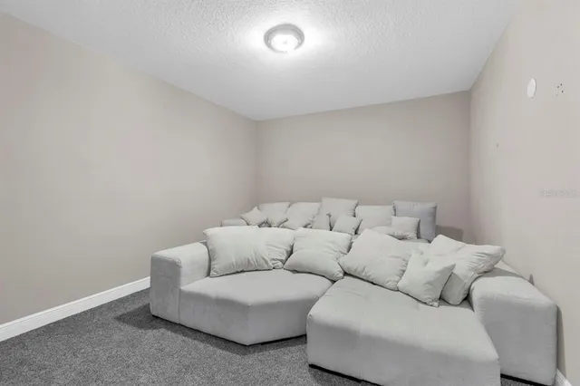 a bedroom with a bed and a view of kitchen