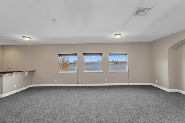 a bathroom with a double vanity sink a large mirror and a bathtub