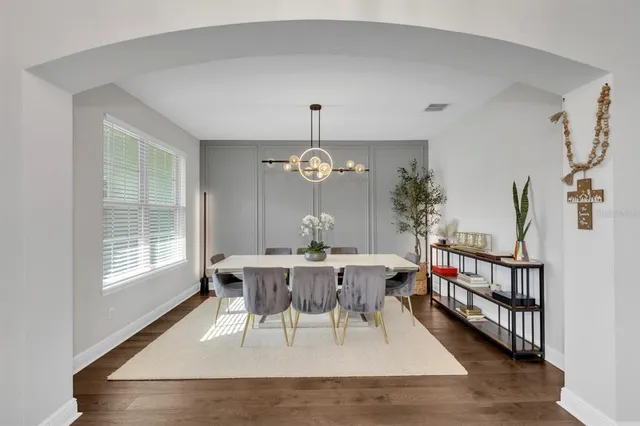 a view of a dining room with furniture window and wooden floor