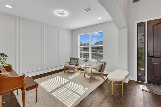 a view of staircase with lots of frames on wall and wooden floor
