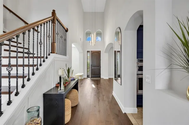 a view of entryway and hall with wooden floor