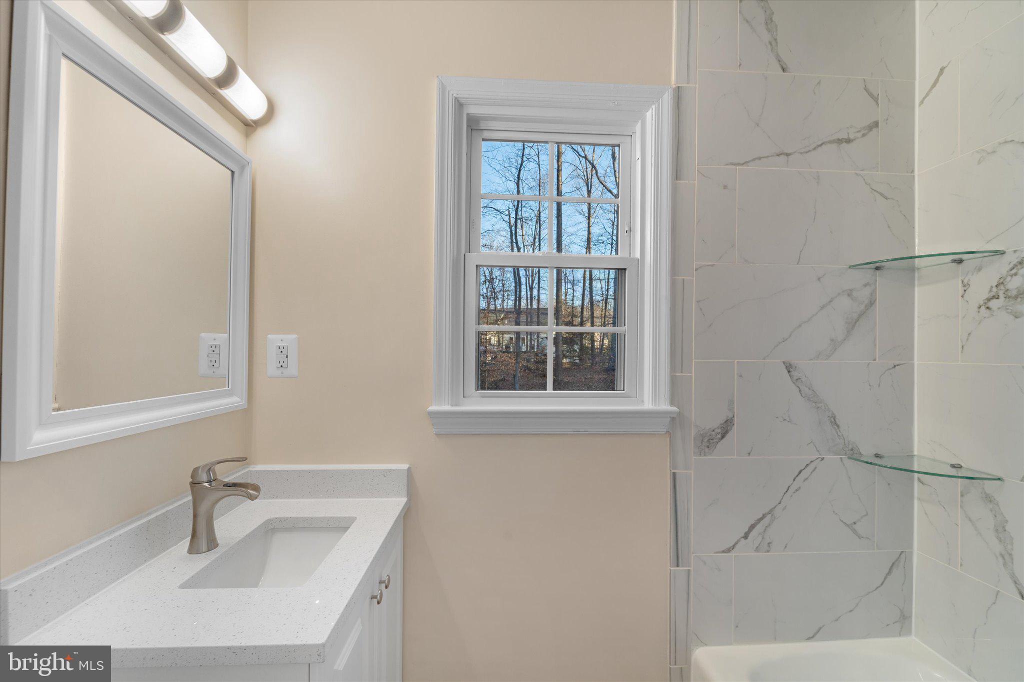 8016 Stillbrooke Road Manassas, VA 20112 - Photo 33 of 41 a bathroom with a sink and a bathtub