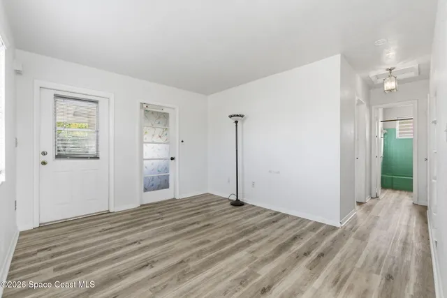 a view of a room with wooden floor and bathroom