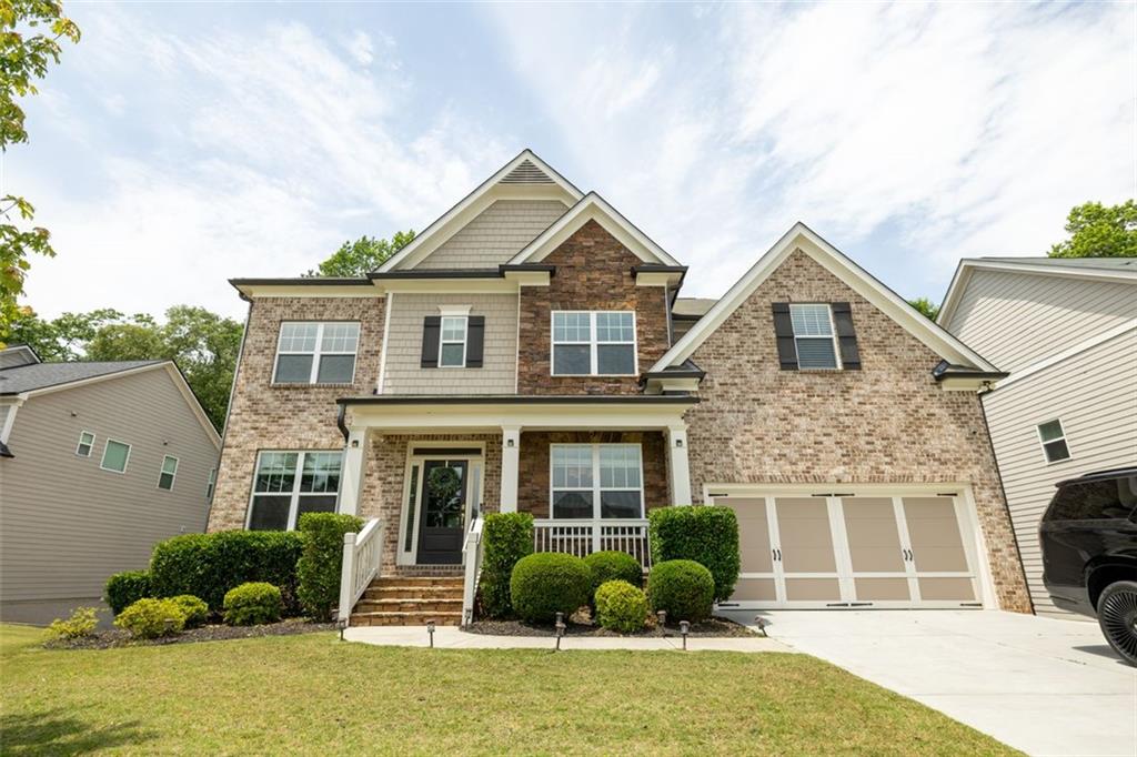 a front view of a house with garden