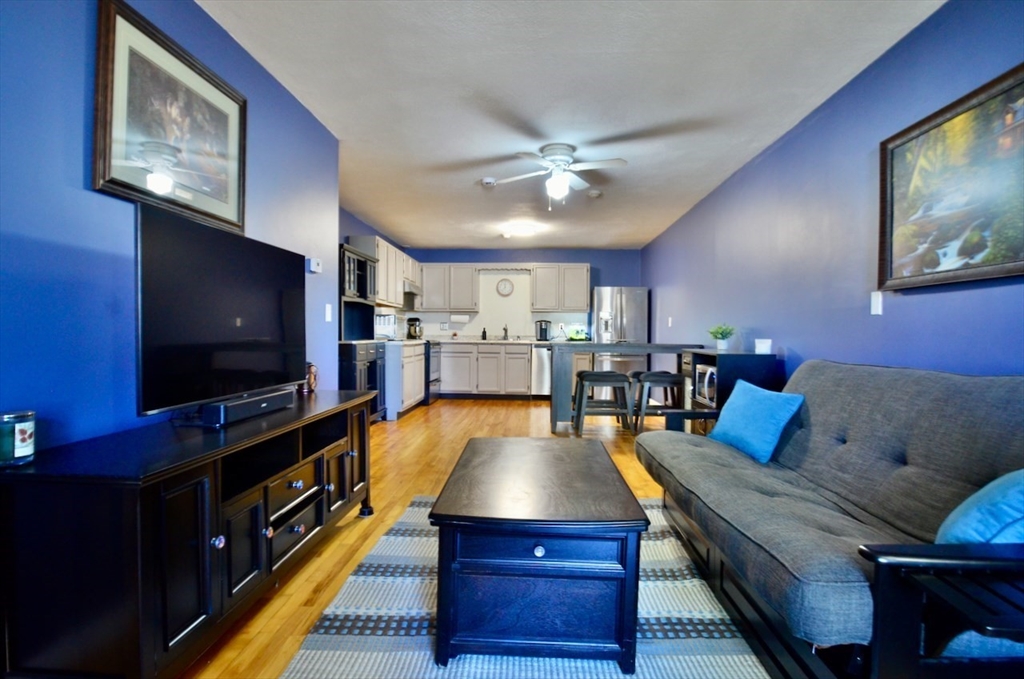 444 Woodward Road, Unit 32 North Providence, RI 02904 - Photo 3 of 15 a living room with furniture and a flat screen tv