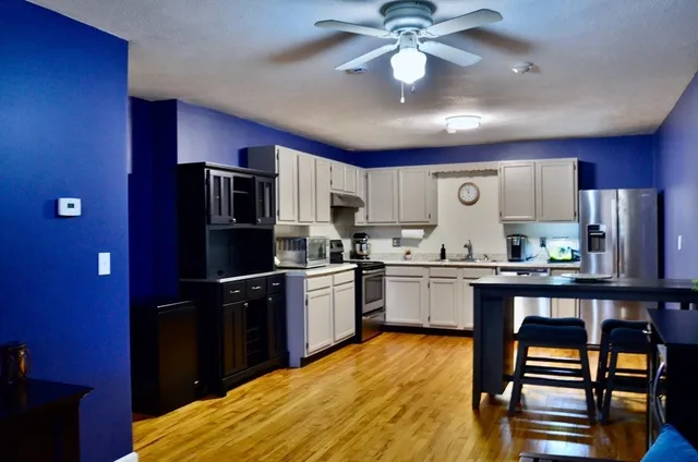 a kitchen with stainless steel appliances granite countertop a refrigerator stove microwave and sink