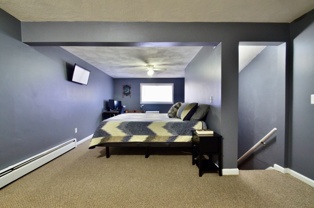 444 Woodward Road, Unit 32 North Providence, RI 02904 - Photo 7 of 15 a bed room with a bed and a window