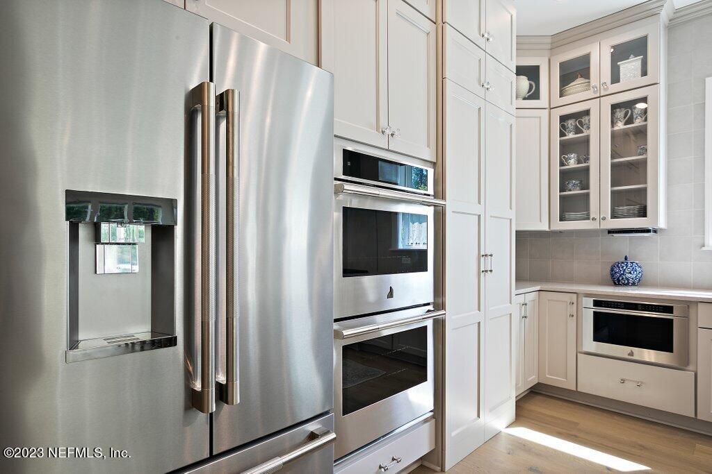 367 Shadow Cove St. Johns, FL 32259 - Photo 17 of 73 a kitchen with stainless steel appliances a refrigerator stove and cabinets