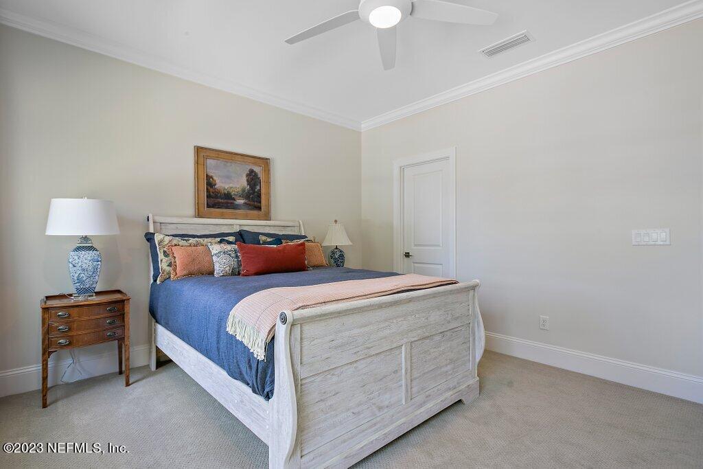 367 Shadow Cove St. Johns, FL 32259 - Photo 42 of 73 a bedroom with a bed and a lamp on dresser