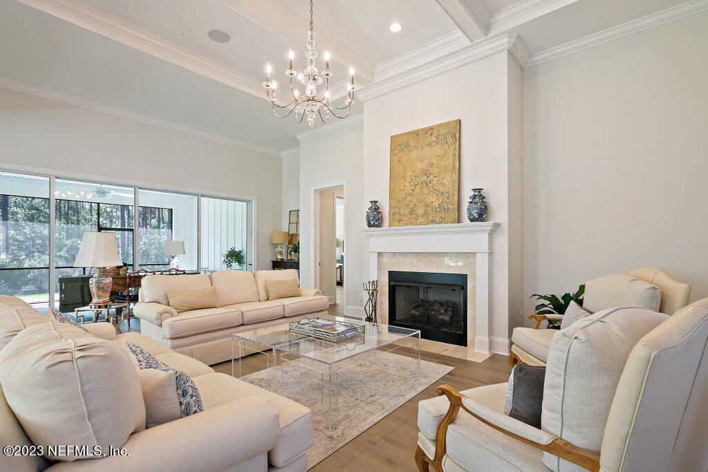 367 Shadow Cove St. Johns, FL 32259 - Photo 9 of 73 a living room with furniture a chandelier and a fireplace