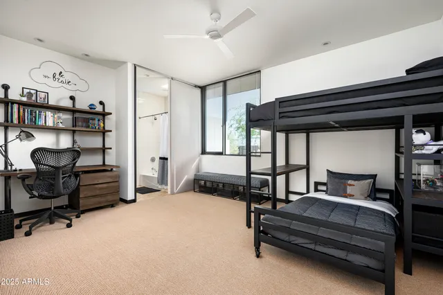 a bedroom with furniture and a book shelf