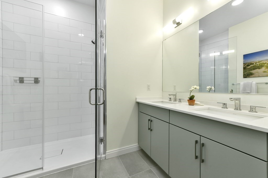 3531 Washington Street, Unit 226 Boston, MA 02130 - Photo 13 of 35 a bathroom with a double vanity sink mirror and shower