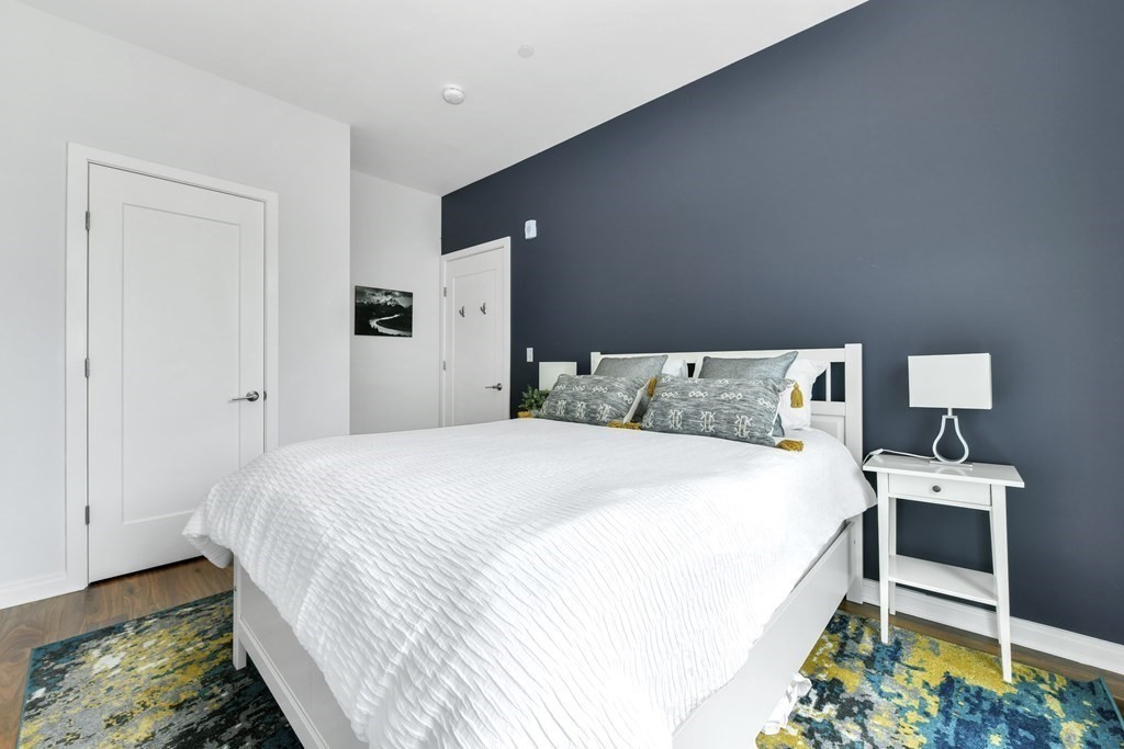 3531 Washington Street, Unit 226 Boston, MA 02130 - Photo 18 of 35 a bedroom with a bed and a dresser