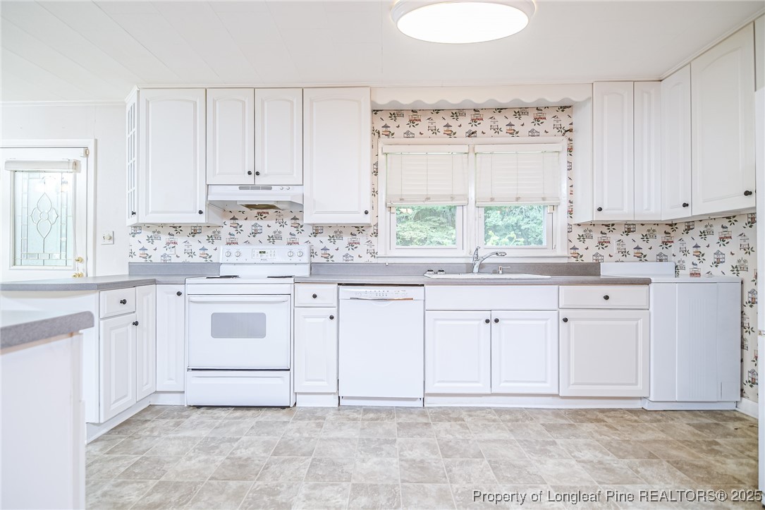 2067 Wade-Stedman Road Stedman, NC 28391 - Photo 16 of 29 a white kitchen with granite countertop white cabinets and white stainless steel appliances
