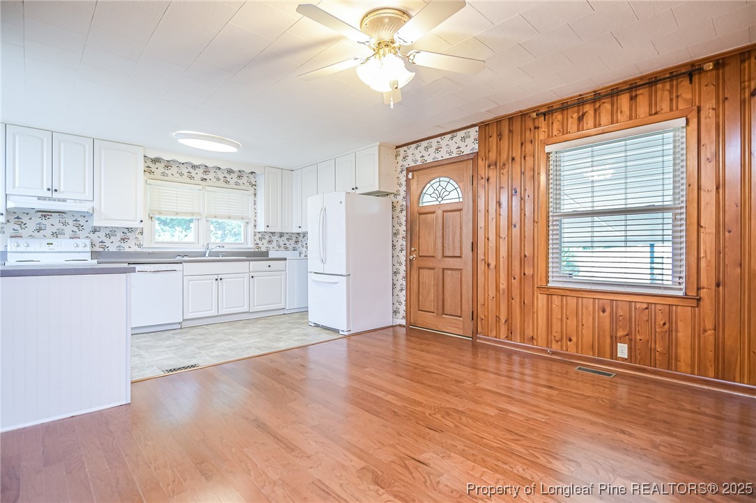 2067 Wade-Stedman Road Stedman, NC 28391 - Photo 4 of 29 a kitchen with stainless steel appliances granite countertop a refrigerator a sink dishwasher a stove and white countertops with wooden floor