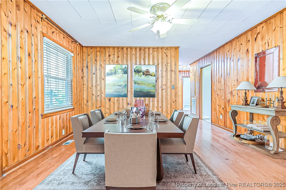 2067 Wade-Stedman Road Stedman, NC 28391 - Photo 7 of 29 a dining room with furniture a chandelier and wooden floor
