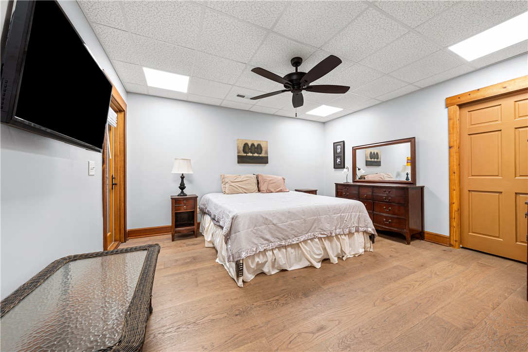 285 Bertha Allen Road Westminster, SC 29693 - Photo 23 of 50 Well-lit sleeping quarters with rich hardwood flooring and a functional ceiling fan.