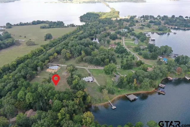 an aerial view of residential house with outdoor space and lake view