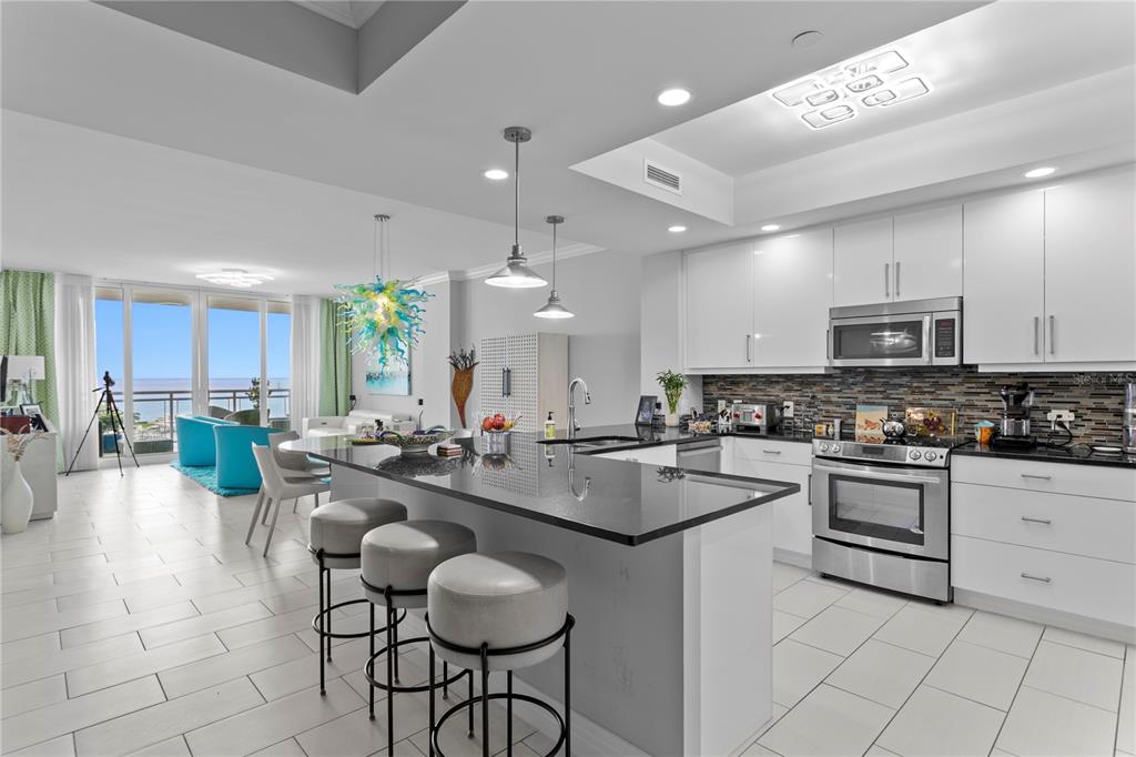 1325 Snell Isle Boulevard Northeast, Unit 711 St. Petersburg, FL 33704 - Photo 17 of 37 a kitchen with sink cabinets and dining table