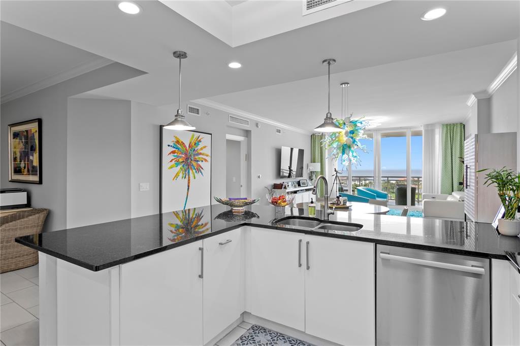 1325 Snell Isle Boulevard Northeast, Unit 711 St. Petersburg, FL 33704 - Photo 18 of 37 a kitchen with stainless steel appliances a sink stove and cabinets