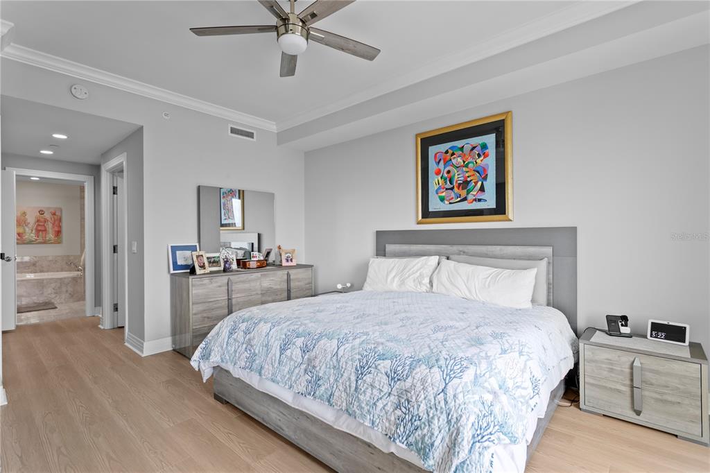 1325 Snell Isle Boulevard Northeast, Unit 711 St. Petersburg, FL 33704 - Photo 21 of 37 a bedroom with a large bed and a chandelier