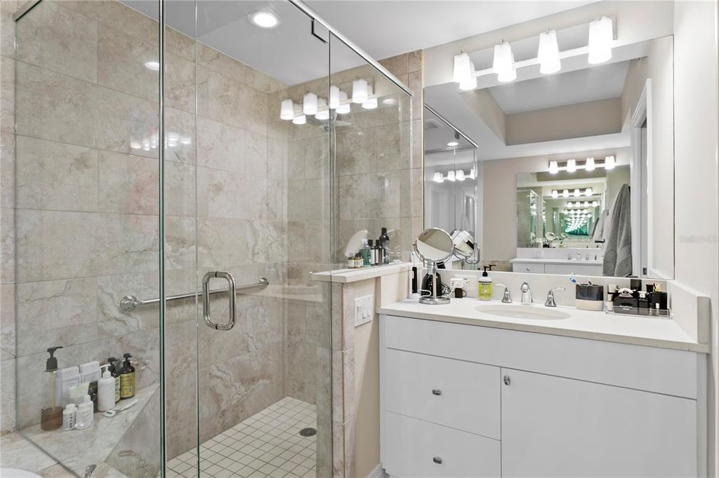 1325 Snell Isle Boulevard Northeast, Unit 711 St. Petersburg, FL 33704 - Photo 26 of 37 a bathroom with a double vanity sink mirror and shower