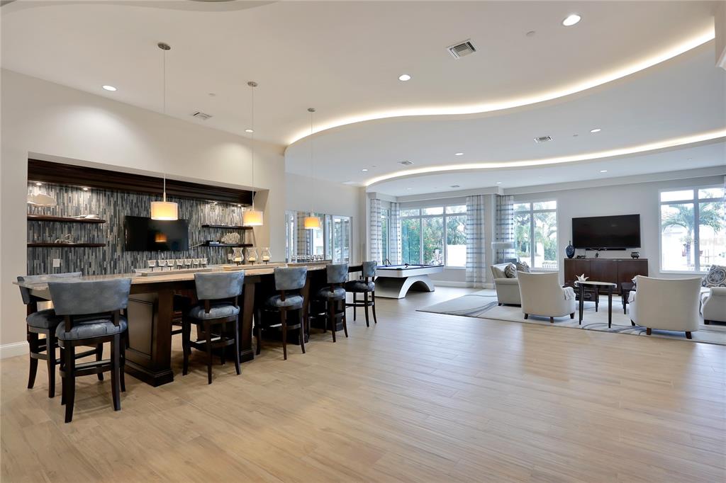 1325 Snell Isle Boulevard Northeast, Unit 711 St. Petersburg, FL 33704 - Photo 32 of 37 a large kitchen with lots of furniture a sink dining table and chairs