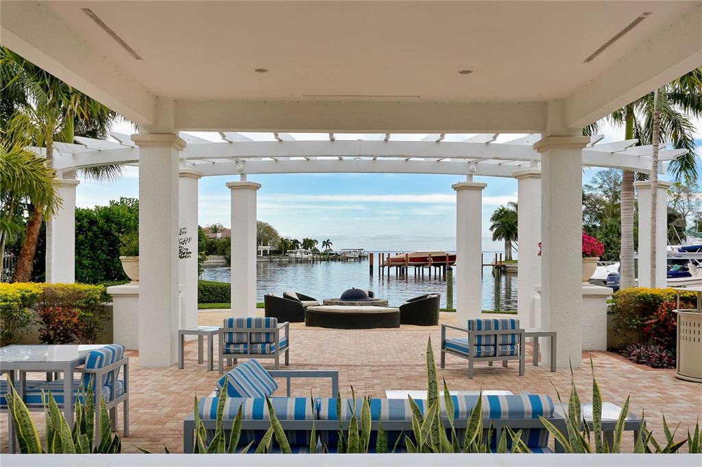 1325 Snell Isle Boulevard Northeast, Unit 711 St. Petersburg, FL 33704 - Photo 7 of 37 a outdoor living space with patio furniture and a floor to ceiling window