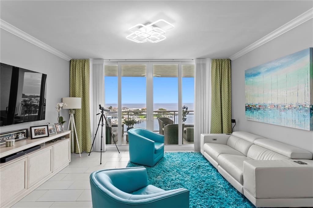 1325 Snell Isle Boulevard Northeast, Unit 711 St. Petersburg, FL 33704 - Photo 10 of 37 a living room with furniture and a flat screen tv