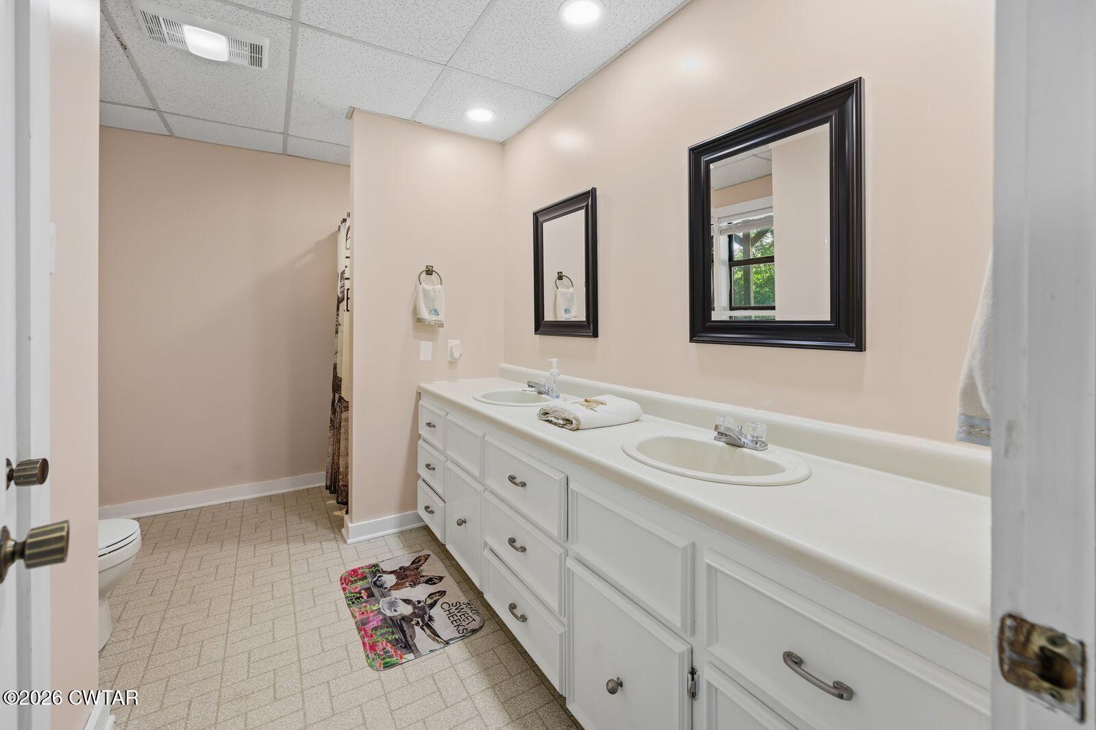 4110 Corinth Road Lexington, TN 38351 - Photo 21 of 59 a bathroom with a sink a vanity and a mirror