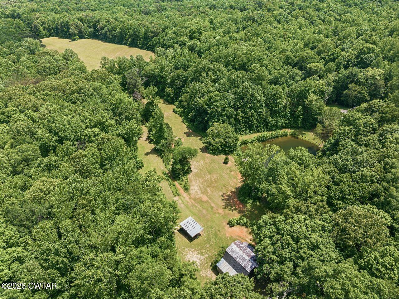 4110 Corinth Road Lexington, TN 38351 - Photo 50 of 59 an aerial view of residential house with outdoor space and trees all around