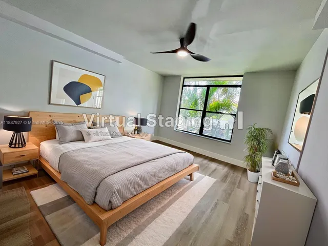 a bedroom with a bed and a large window