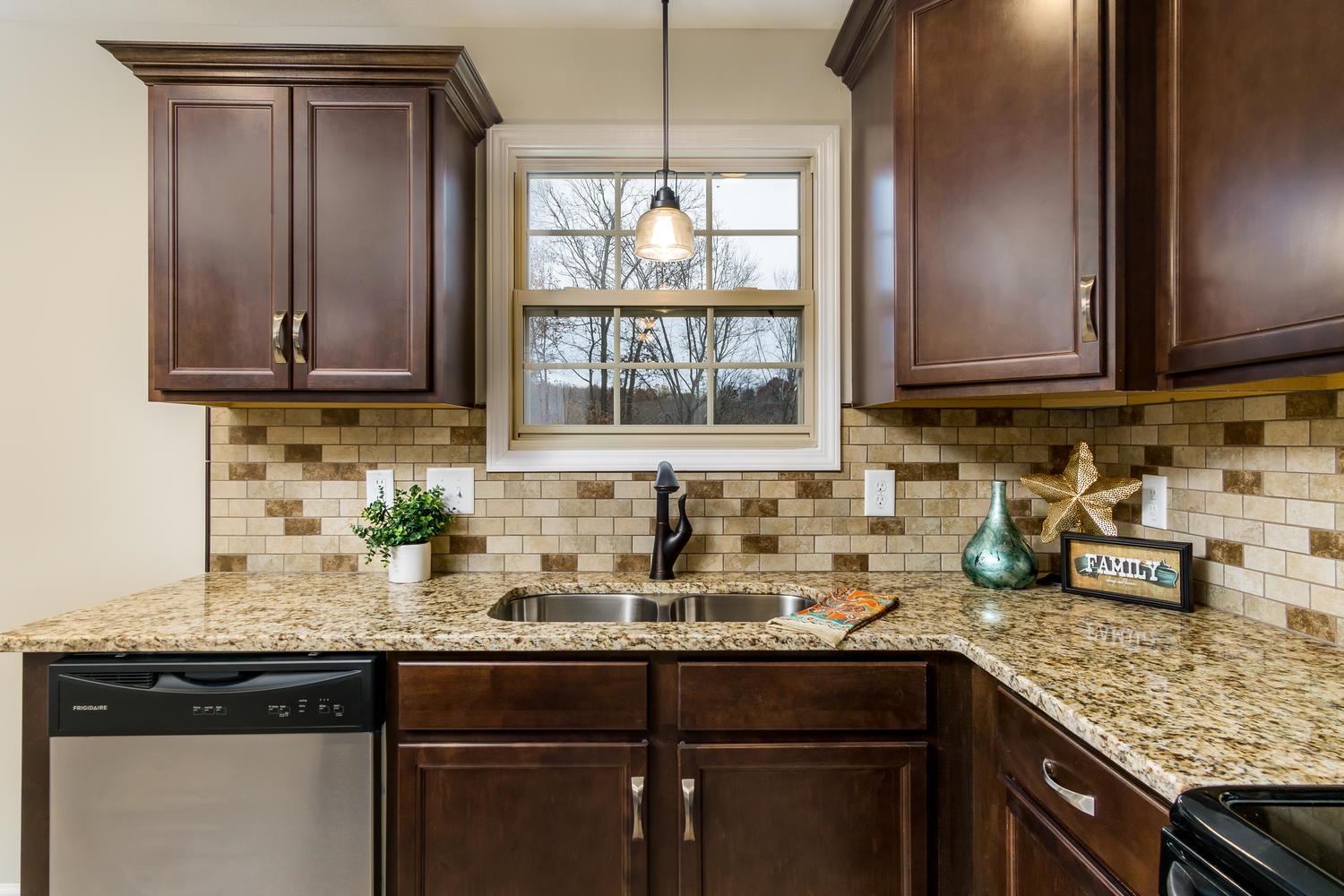 2645 Mockingbird Hill Road Palmyra, TN 37142 - Photo 14 of 27 a kitchen with granite countertop a sink window and cabinets