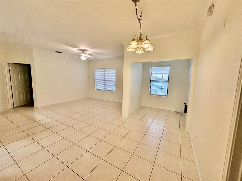 2199 Chianti Place, Unit 912 Palm Harbor, FL 34683 - Photo 4 of 20 a view of a livingroom with a chandelier fan and windows