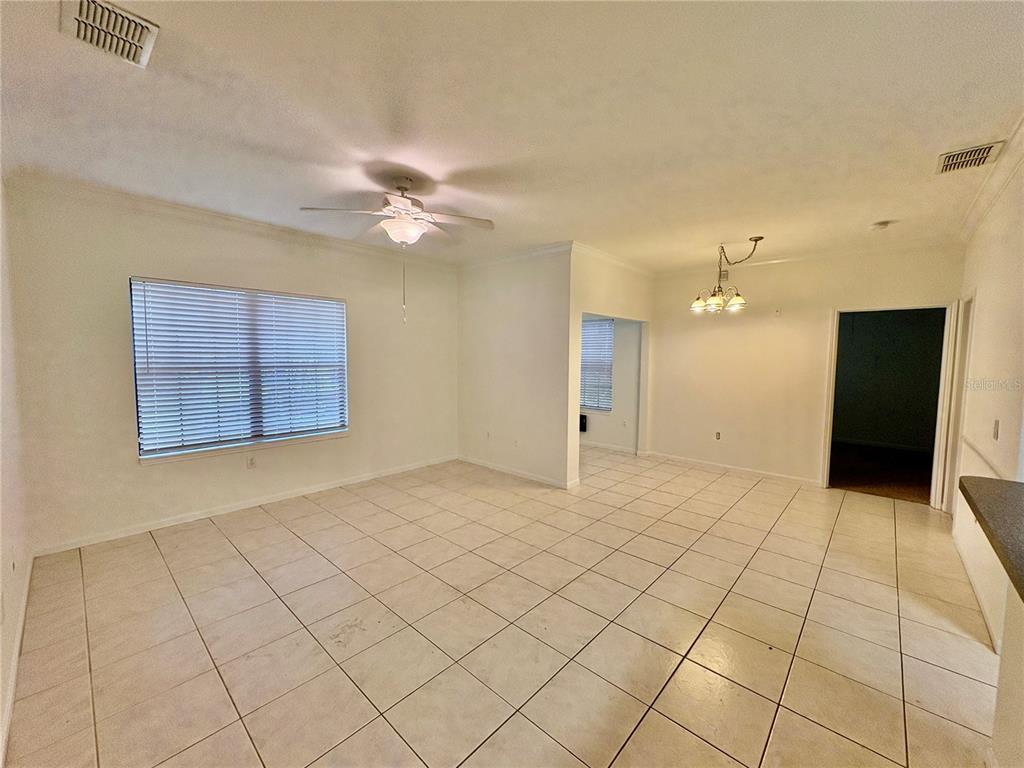 2199 Chianti Place, Unit 912 Palm Harbor, FL 34683 - Photo 5 of 20 a view of an empty room and chandelier fan
