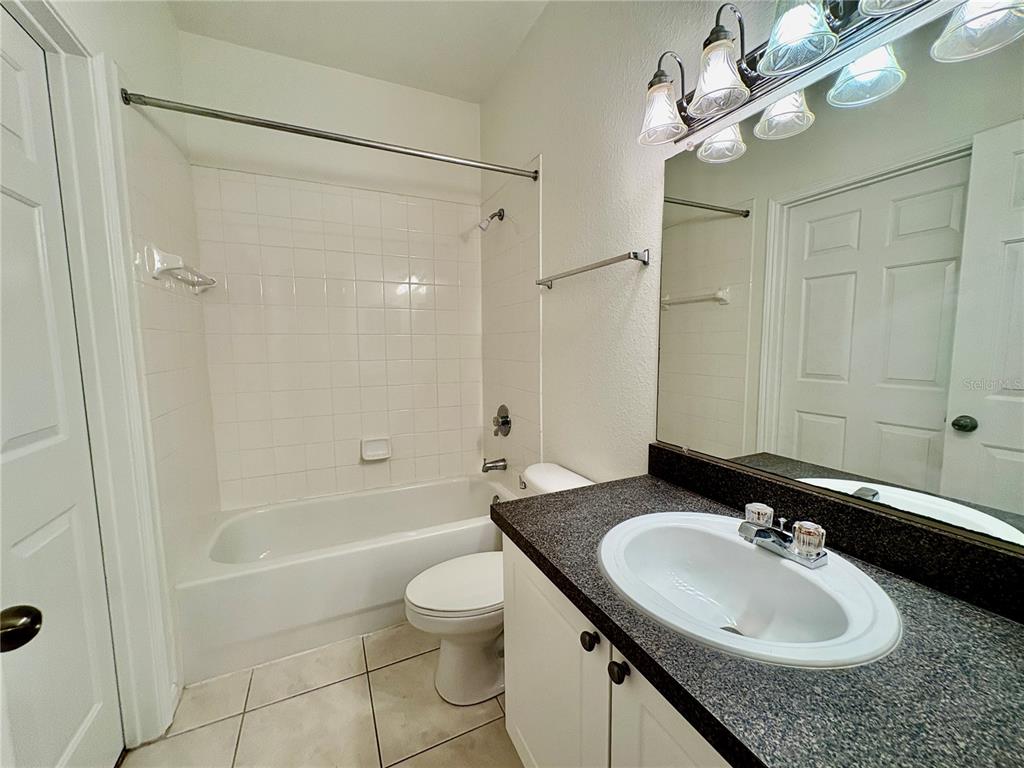 2199 Chianti Place, Unit 912 Palm Harbor, FL 34683 - Photo 10 of 20 a bathroom with a sink a toilet and shower