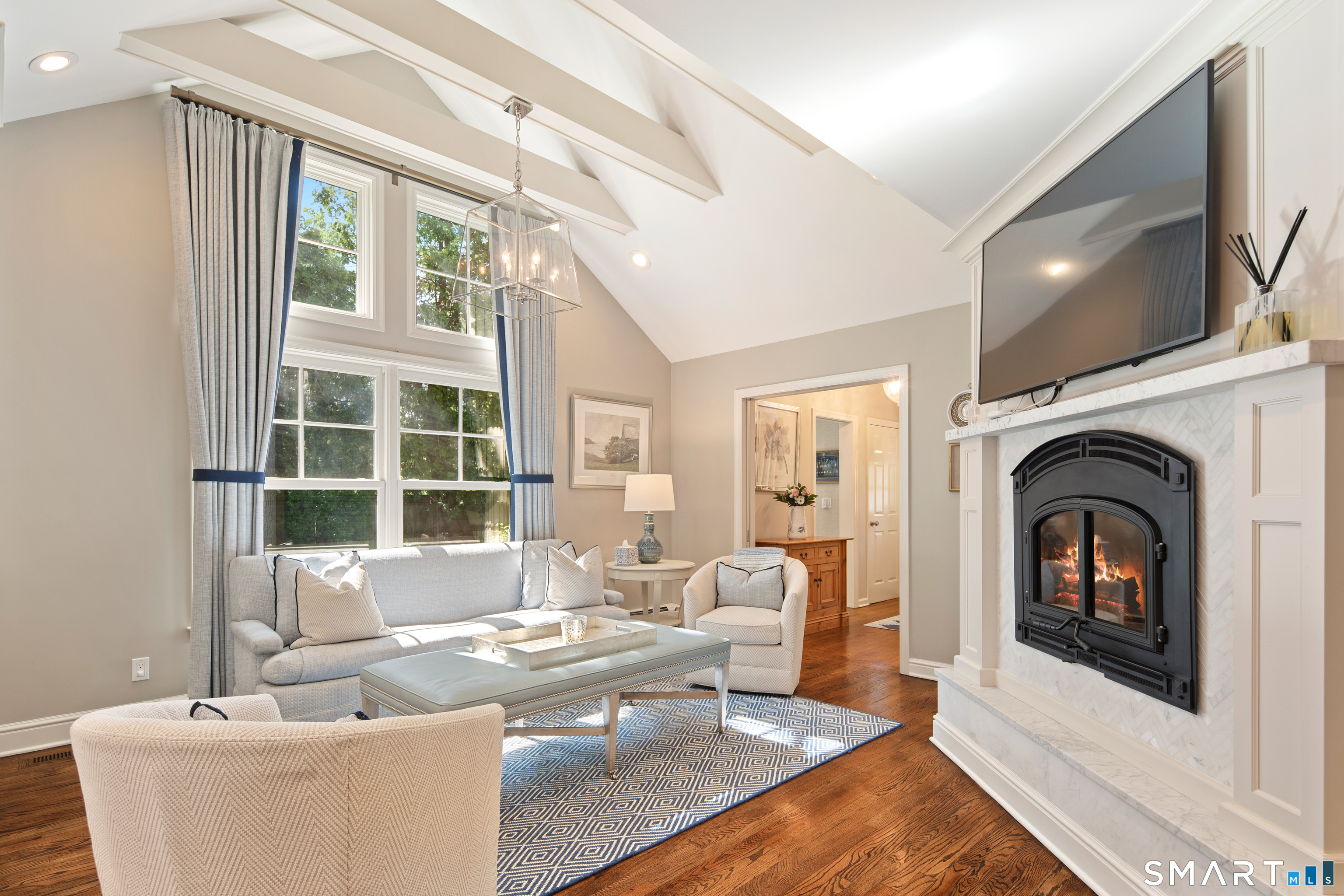 11 McLaren Road South Darien, CT 06820 - Photo 30 of 40 a living room with furniture a flat screen tv and a fireplace