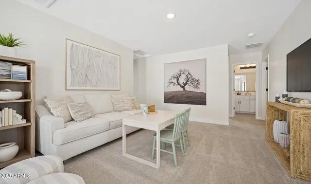 a view of staircase with lots of frames on wall and wooden floor