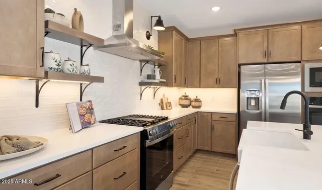 a kitchen with a sink a stove and chairs